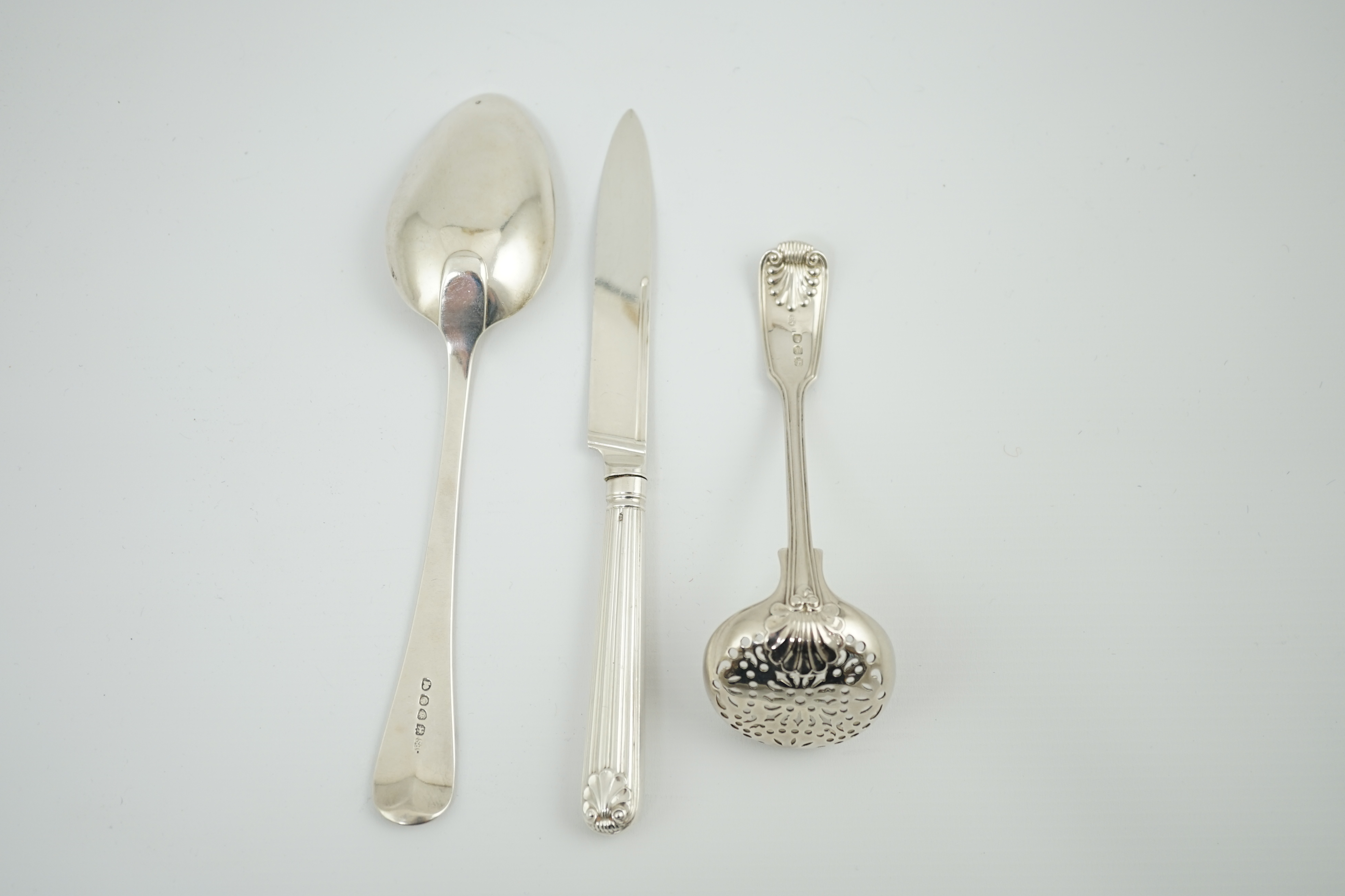 Paul Storr. A George III silver fiddle, thread and shell pattern sifter ladle, London, 1815, 13.9cm, a similar Old English pattern table spoon, London, 1818, 21.2cm, 4oz and a dessert knife, London, 1812.